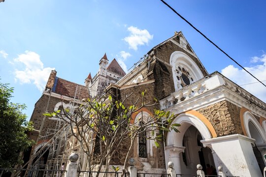 Historic Stone Church Exterior Under Blue Sky with Clouds, Galle, Sri Lanka