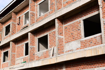 Obraz premium exterior view of brick house under construction with concrete structure