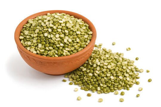 Studio photo of dry split green moong dal in a terracotta bowl isolated on white background with scattered seeds