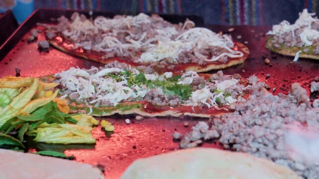 Chef preparing traditional mexican memelas on a griddle