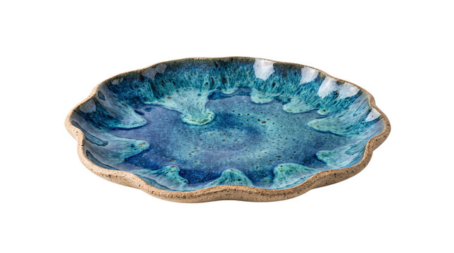 Artisanal blue ceramic plate with scalloped edges, handmade stoneware dish with reactive turquoise glaze, rustic pottery serving tray isolated PNG with Transparent Background
