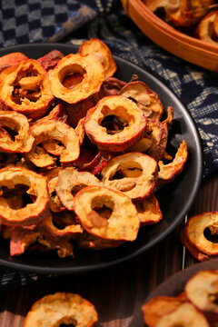 Dried hawthorn berry slices on a black plate