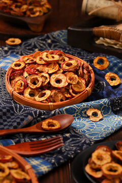 Dried hawthorn fruit slices served in a rustic bamboo basket