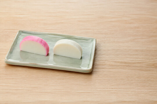 Red and white Japanese kamaboko on a small plate for New Year