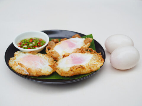Several fried duck eggs are arranged on a plate; they look appetizing and wonderfully crispy. Protein, fried eggs.