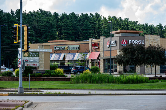 Wausau, WI, USA - Jul 11, 2026: A commercial building featuring restaurants and local businesses on a summer day.