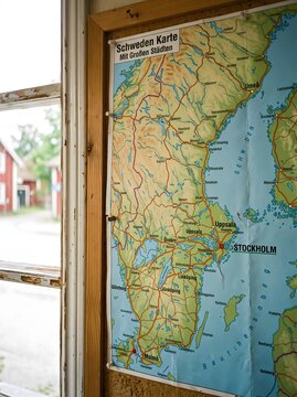 Sweden map with major cities pinned on corkboard near window, travel planning and navigation concept