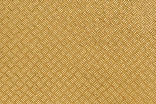 Yellow metal texture with a raised diamond plate pattern and bold industrial finish. Durable steel surface ideal for flooring, stairs, panels, machinery, construction, and architectural backgrounds.