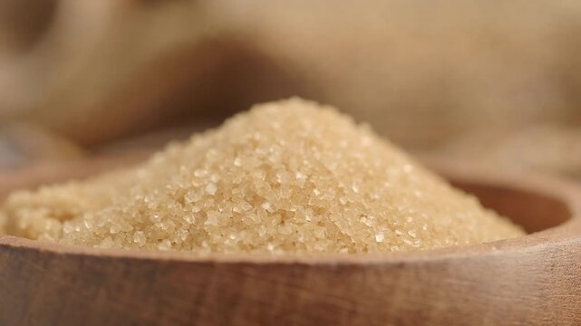 Brown sugar in a wooden bowl on a kitchen table