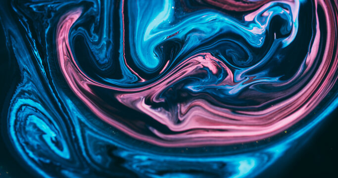 Shiny ink. Acrylic flow. Blur blue pink purple color mix sparkling marble texture glitter fluid floating on abstract art background.