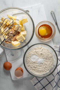 Bowls of combined ingredients for making pecan pie cookies. 