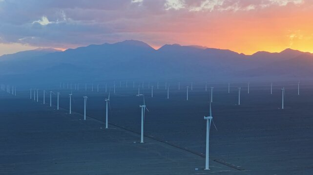 Wind farms at sunset in the Gobi Desert, windmills generating electricity, new energy.
