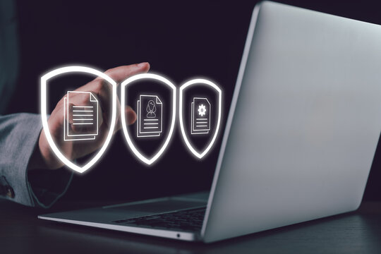 Business data protection concept with a professional using a laptop and secure document icons