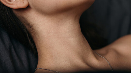 Obraz premium Female neck and clavicle with delicate thin silver chain