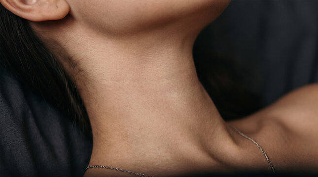 Female neck and clavicle with delicate thin silver chain