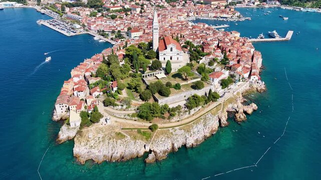 Aerial drone view of the old town peninsula, the rocky coast and the clear turquoise water, Rovinj, Croatia