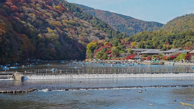 Beautiful landscape of Katsura River at Arashiyama with foliage autumn and blue sky in Kyoto, Japan