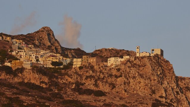 Mountain village in warm morning light with striking rock formations and clouds, Mountain village Menetes, Morning light, Karpathos, Dodecanese, Greek Islands, Greece