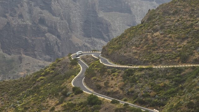Serpentine road snakes along a steep rock face surrounded by barren vegetation, Masca, Barranco de Masca, Gorge, Teno, Teno Mountains, Northwest Tenerife, Tenerife, Canary Islands, Spain