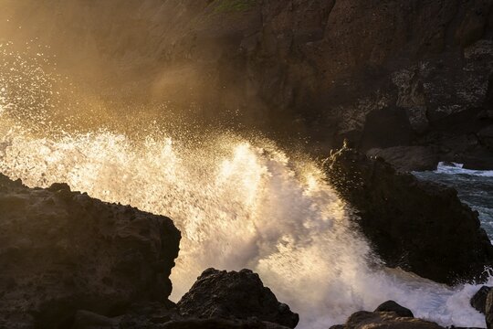 Rocks and sea spray on the beach of San Marcos at sunrise. La Gomera, Canary Islands, Spain