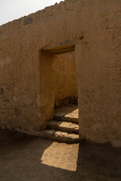 Ancient trapezoidal adobe door with stone lintel and steps at the Huayc&aacute;n de Cieneguilla archaeological site, Peru.