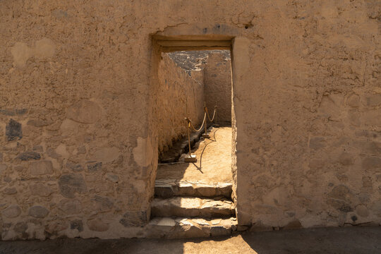 Ancient trapezoidal adobe door with stone lintel and steps at the Huayc&aacute;n de Cieneguilla archaeological site, Peru.
