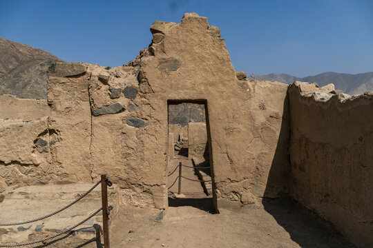 Ancient trapezoidal adobe door with stone lintel and steps at the Huayc&aacute;n de Cieneguilla archaeological site, Peru.