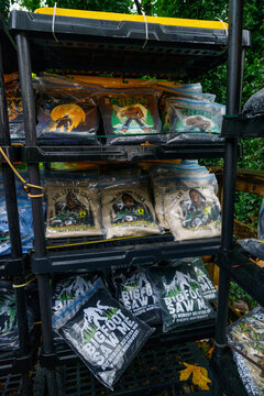 Shelves of Bigfoot themed coffee bags at the Espresso Chalet, packages reading The Legend Lives and Bigfoot Saw Me stacked in plastic in the damp forest air.