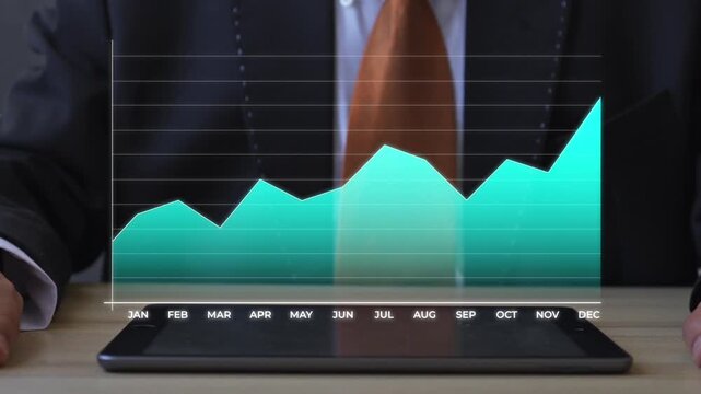 Close up of Businessman taps tablet screen to display animated financial growth chart