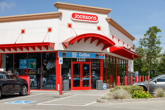 The red and white Jacksons convenience store storefront advertises 99 cent coffee under a scalloped awning, cars parked outside on a sunny Federal Way afternoon.