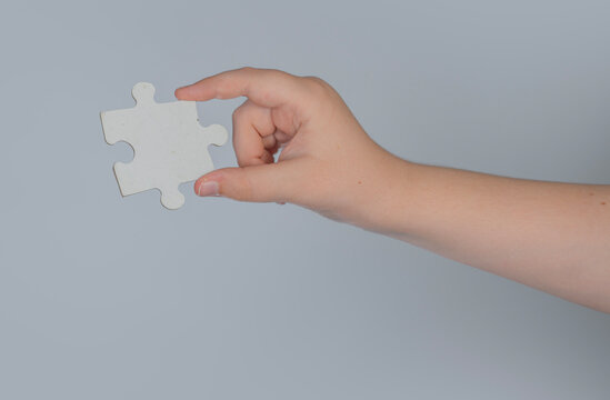 Connecting puzzle piece shows missing link. Connecting concept supports planning strategy. Hand gesture shows connecting solution idea. Jigsaw link makes connecting symbol.