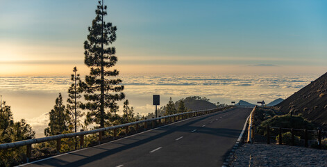 Naklejka premium Tenerife volcanic peak dominates landscape. Tenerife scenic road crosses lava field. Spectacular Tenerife mountain attracts tourism. Tenerife volcanic terrain inspires photographers.