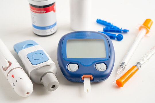Glucometer lancet and test stick measuring human blood sugar level for diabetes.