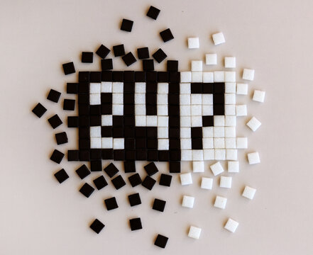 The word 24/7 is laid out from white and black mosaic cubes.
