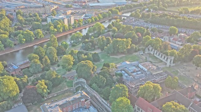 Museum Gardens contains St Mary's Abbey ruins, the Yorkshire Museum and Lendal Tower beside the River Ouse, with historic walls and gardens, York, England, aerial shot