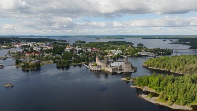 Panoramic drone shot of the Olavinlinna castle and downtown Savonlinna, Finland