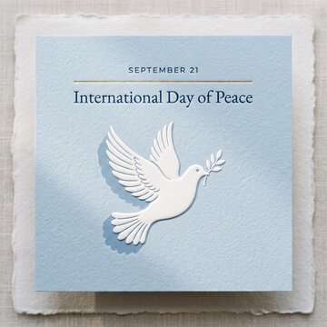 International Day of Peace Greeting Card with White Dove and Olive Branch on Blue Textured Paper Background