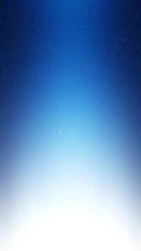 Rising transparent air bubbles floating upwards through clear water in this beautiful blue abstract motion background video clip effect