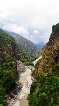 Vertical drone shot along the Trishuli River in Langtang National Park, Nepal