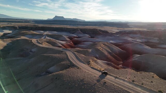 Drone Shot of ATV Vehicle Moving on Hill in Lifeless Desert Landscape of Utah USA