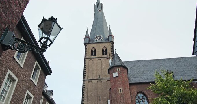 Saint Lambert Basilica Dusseldorf Germany Romanesque architecture shows the historic church with its distinctive bell tower in the urban landscape of a European tourist city. 