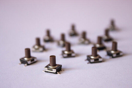 Small Electronic Push Buttons on White Background