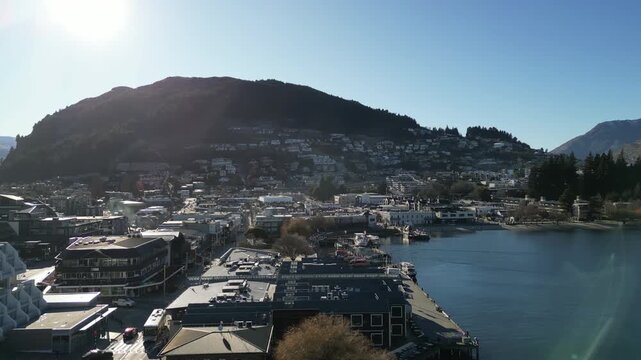 Queenstown cityscape aerial view showcases Lake Wakatipu in New Zealand with beautiful Southern Alps mountains scenic tourist landmarks and dramatic natural landscapes for travel tourism