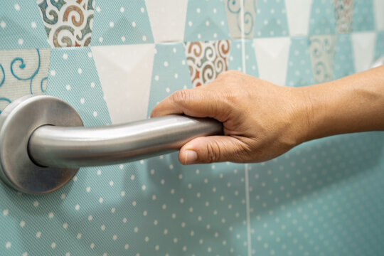 Asian elderly woman use toilet bathroom handle security, healthy strong medical.