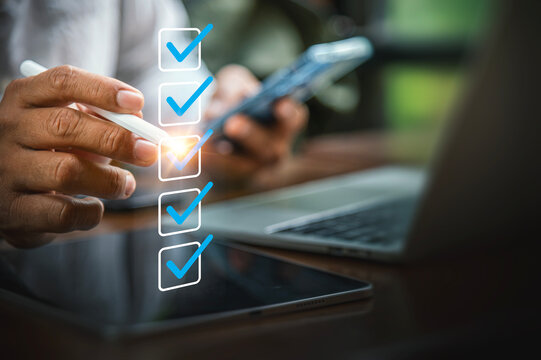 Close Up of Hands Using Tablet and Phone with Virtual Quality Control Checklist.