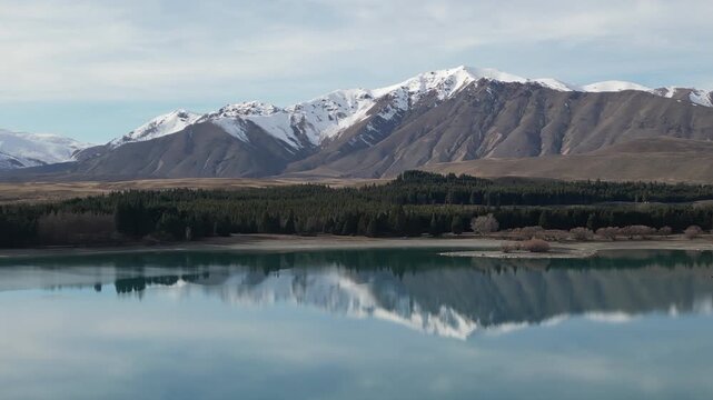 Lake Tekapo aerial view showcases beautiful New Zealand nature surrounded by Southern Alps mountains, snowy peaks and dramatic scenic landscapes across a peaceful Pacific island