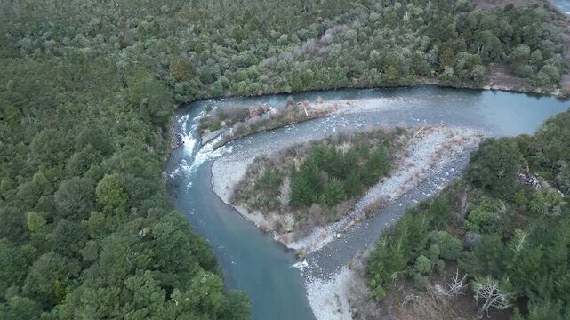 Tongariro River landscape appears in an aerial view of New Zealand with winding banks surrounded by beautiful forests, green nature and scenic scenery for travel tourism