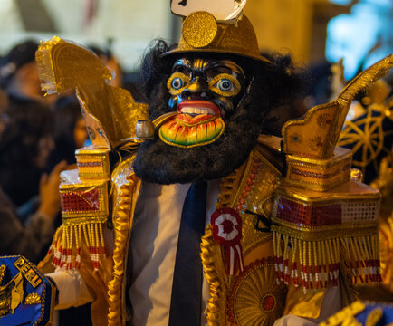 Close Up Details of Dancers in Colorful Traditional Costumes and Masks at a Peruvian Folk Dance Festival Parade