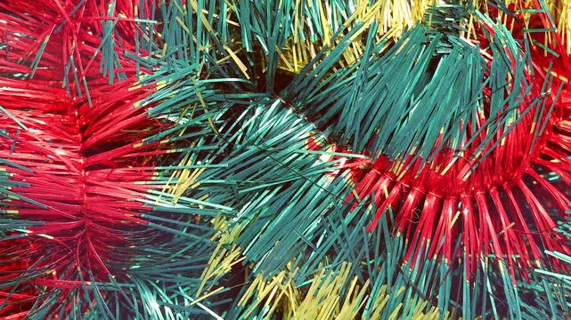 Festive tinsel texture for Christmas and New Year sparkling with golden highlights, abstract holiday background, shimmering decorative backdrop, celebration pattern.