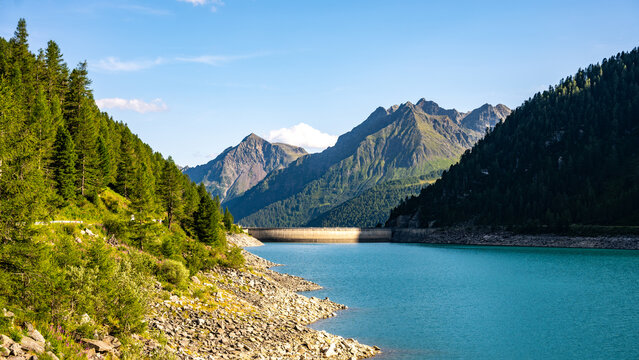 Lake Neves is located at the end of the Molini Valley in South Tyrol, Italy. This area features mountains, clear blue water, and natural landscapes on a sunny day.